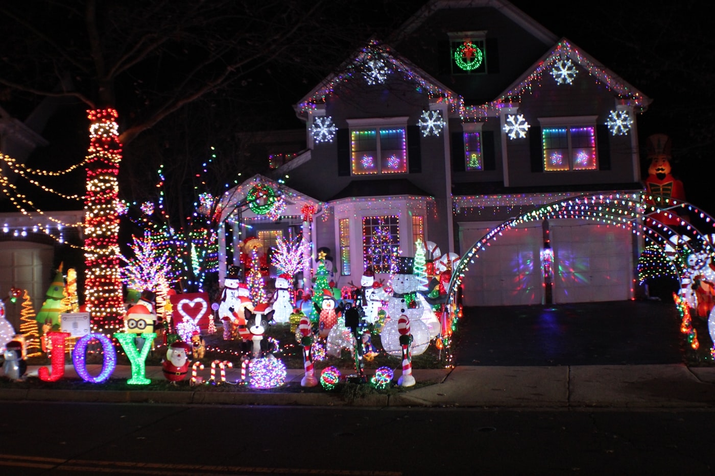 Phoenix home beautifully decorated with professional exterior Christmas lights at night