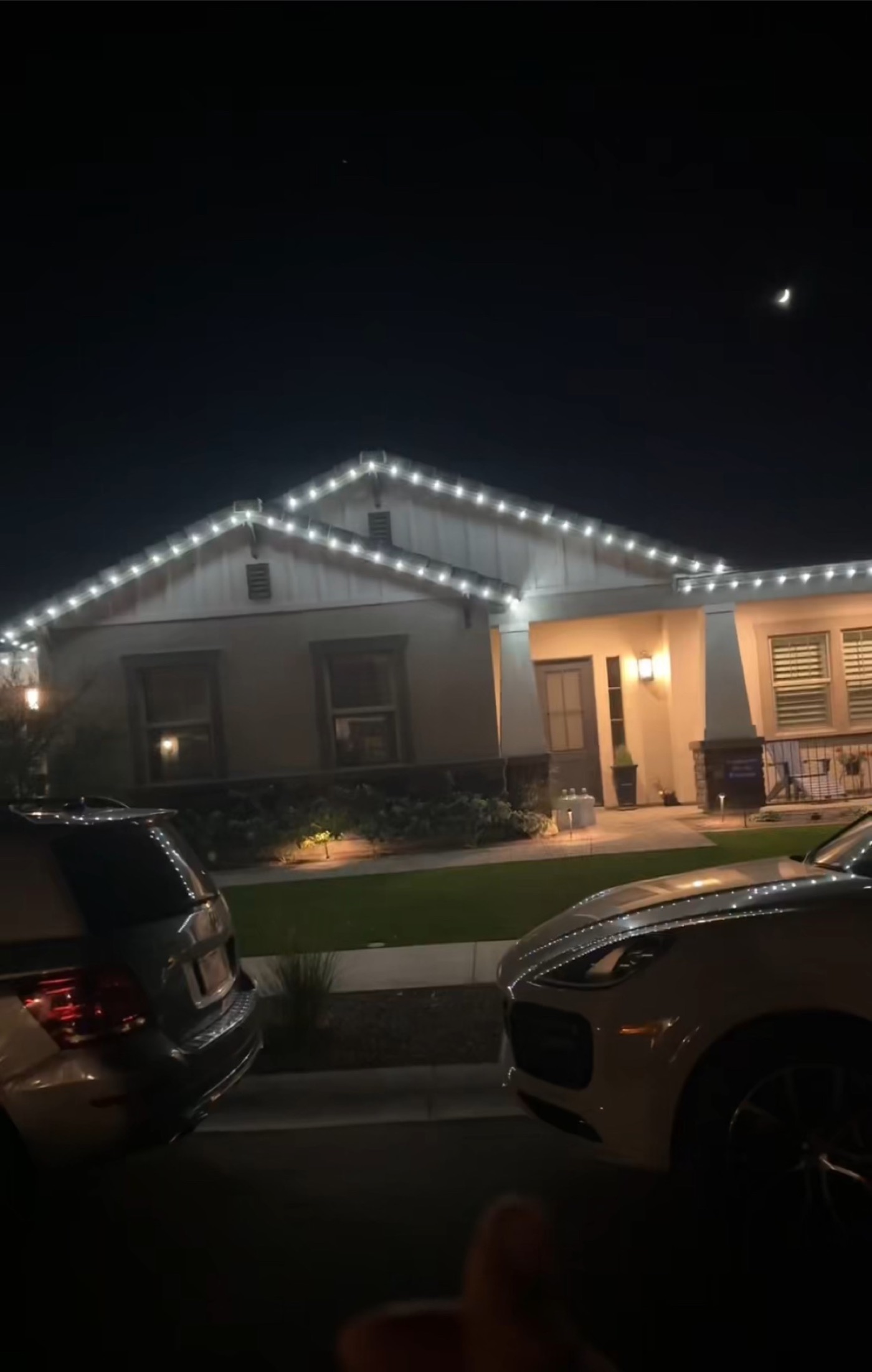 A Phoenix home with its rooflines lit at night