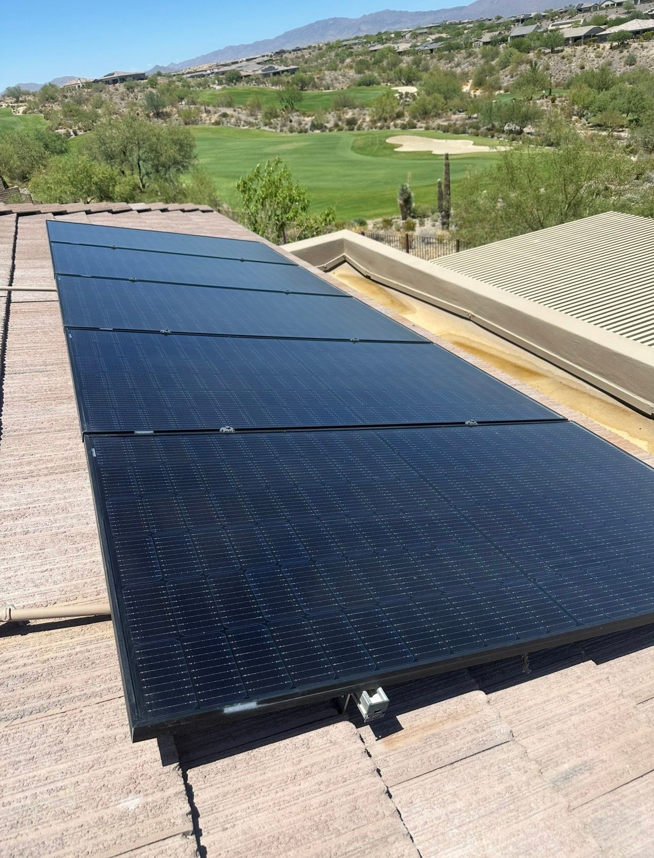 The same roof-mounted solar array after cleaning, glass clear and the cells sharp